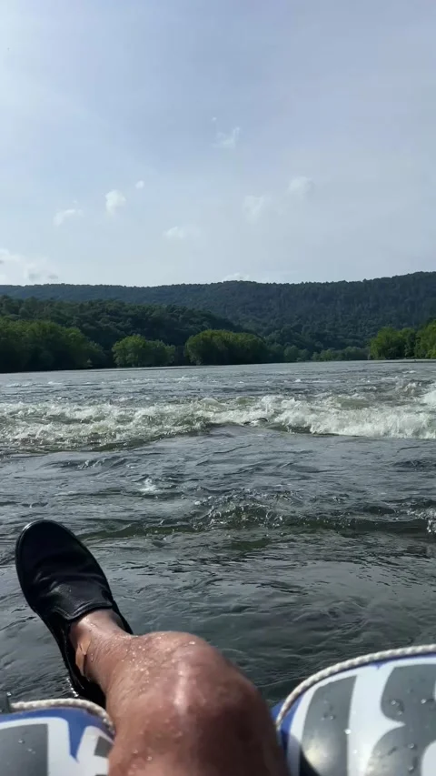 Pov of person going down a river on a float surrounded by beautiful scenery Stock Footage 197132856