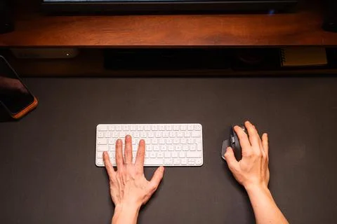 POV Person hands working on computer desk at home Stockfoto's