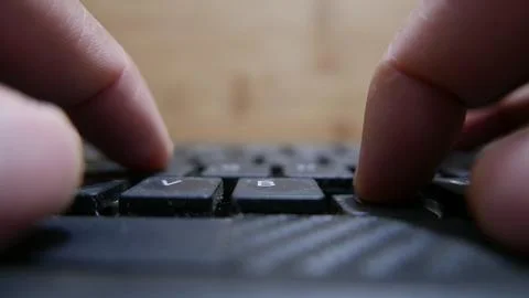 POV: A person typing on a computer keyboard. Bluetooth keyboard, close-up. Stock Photos