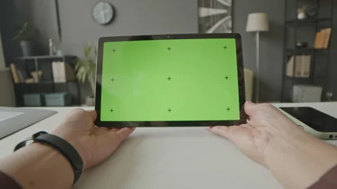 POV of Person Using Digital Tablet with Green Screen in Office Stock Footage 248416973