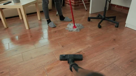 POV of person using vacuum cleaner to tidy up apartment Stock Footage 229584000
