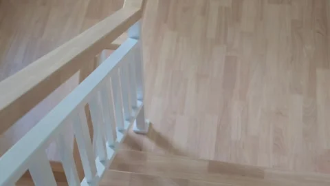 POV personal perspective view. Going down on stairs with wood banister Stock Footage 251142550