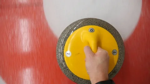 POV, personal point of view of curler sliding curling stone on a sheet of ice Stock Footage 118372754