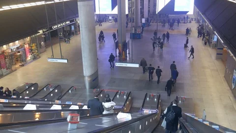 POV perspective going down escalator at London's Canary Wharf Tube Station Stock Footage 102900420