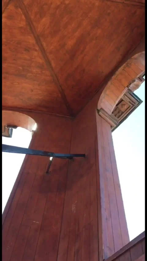 A POV perspective of walking up steep, narrow wooden stairs from a dark area 動画素材 333376754