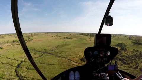POV from pilot and passenger from the inside of a helicopter while flying over Stock Footage 85280481