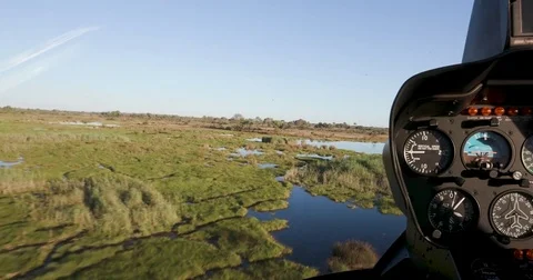 POV from pilot from the inside of a helicopter while flying over the Okavango Stock Footage 85264162