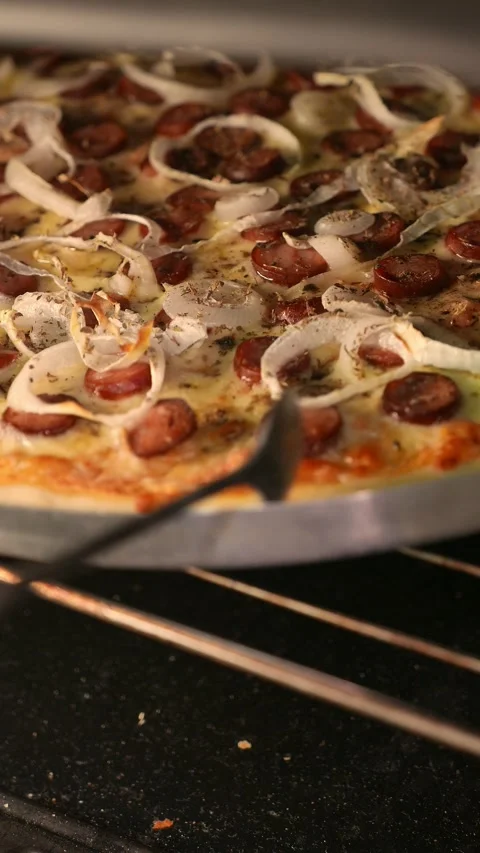 POV: pizzaiolo checking the pizza inside the oven. Chef rotates the pizza Stock Footage 343464650