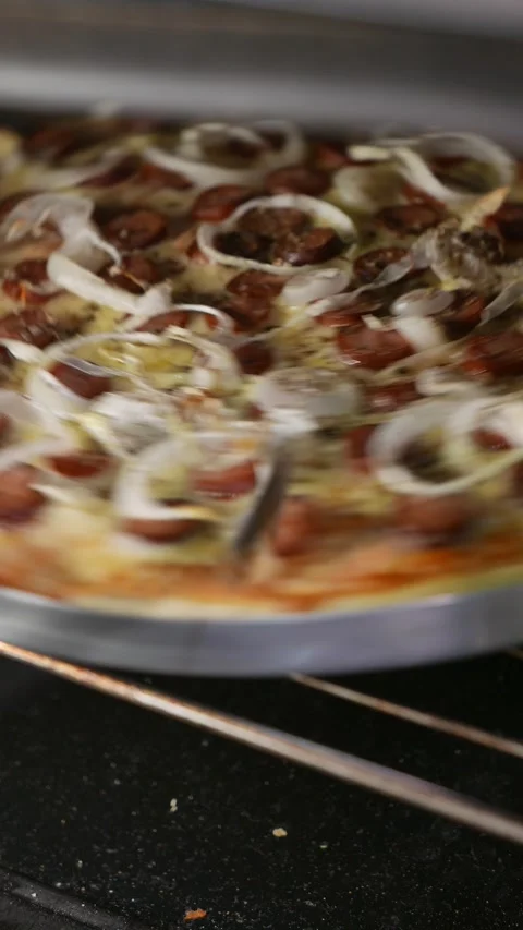 POV: pizzaiolo checking the pizza inside the oven. Chef rotates the pizza Stock Footage 343796200