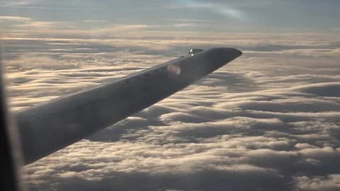 POV Point of view airplane transit beautiful rainy clouds orange light at sunset Stock Footage 81986056