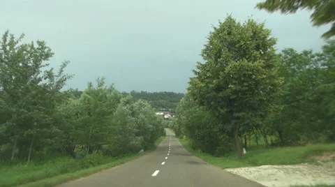 POV point of view car driving cloudy summer day rural road village nature pass  Stock Footage 32637634