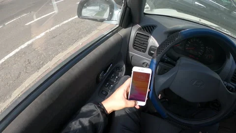 POV point of view checking cell phone and mail inside a car Stock Footage 140414452