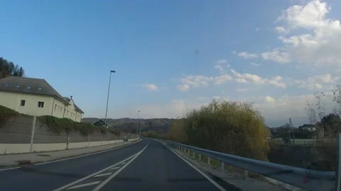 POV, point of view of driving a car on countryside road in small village Stock Footage 169248597