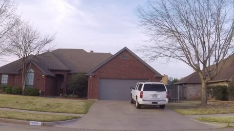 Pov. Point of view - Driving through residential neighborhood in spring time. Video stock 73899820