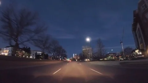 POV point of view - Driving through the city at sunrise. Stock Footage