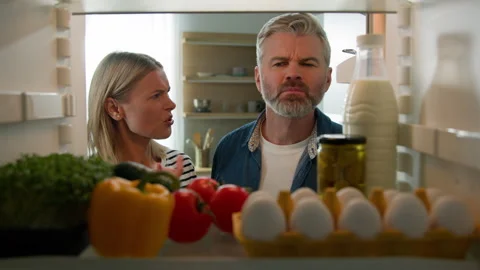 POV Point of view from inside fridge adult couple feeling bad disgusting Stock Footage 241221966