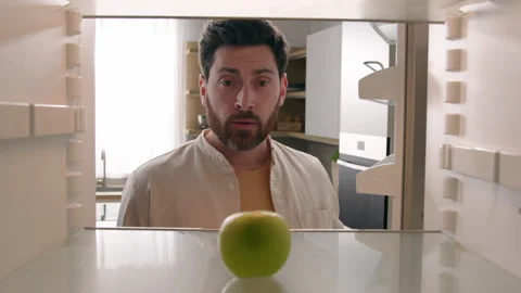 POV point of view from inside refrigerator Caucasian adult man at kitchen open Stock Footage 249821877