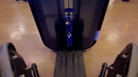 POV (point of view) of legs man in a gym machine exercising his legs, hips Stock Footage 160446754