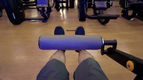 POV (point of view) of legs man in a gym machine exercising his legs, hips Stock Footage 160446763