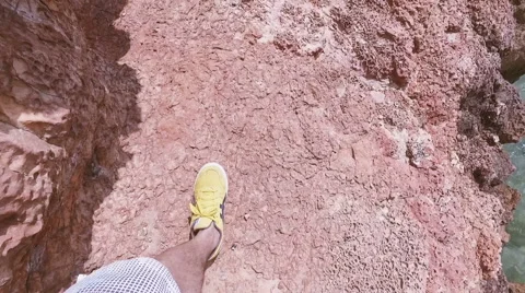 POV point of view Man Walking thru the rocks to the sea Stock Footage 63749456