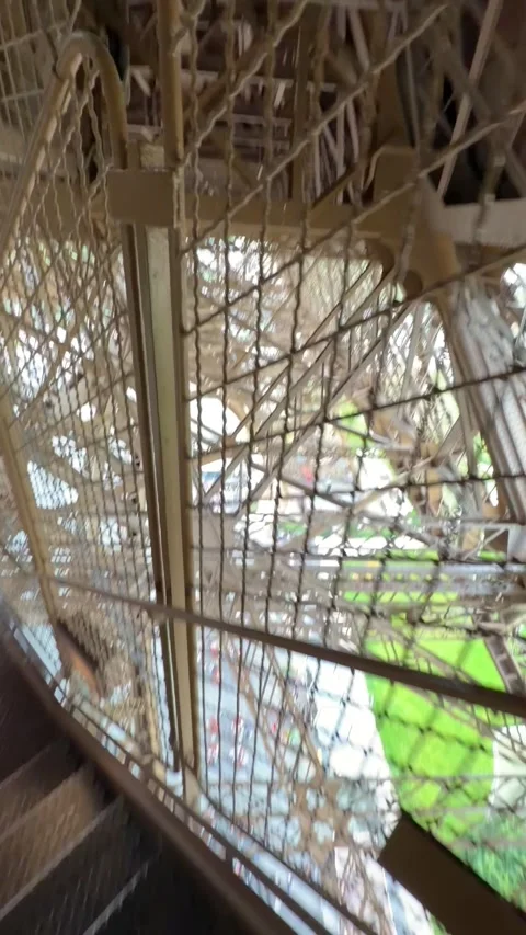 POV Point of view of a person walking down metal stairs inside Eiffel Tower in 스톡 동영상 334188059