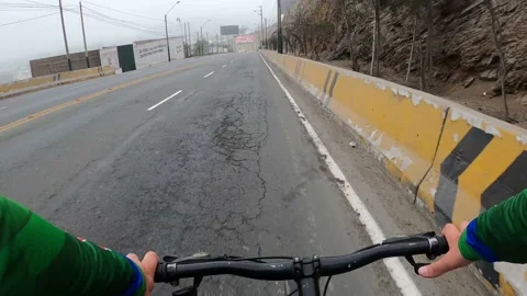 POV point of view riding a bicycle downhill along Raul Ferrero avenue, La Molina Stock Footage 142673960
