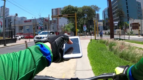 Pov point of view riding bicycle distracted looking at the cell phone Stock Footage 148791671