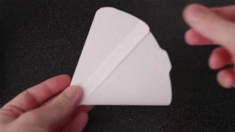POV of preparing paper filter for V60 manual brewing Stock Footage 332720239