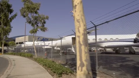 Pov Private Jets John Wayne Airport View through Fence Lines Stock Footage 93522088