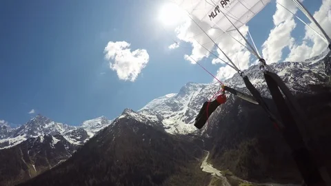 POV of pro parachutist flying above village surrounded by mountains, Aspen Stock Footage 129130153