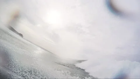 POV of pro surfer laying on back of rescue sled and watching big wave coming Stock Footage 163254060