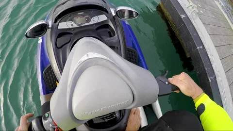 POV of professional surfer sitting down into jet ski joining another surfer Stock Footage 163253042