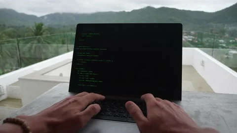 POV of programmer developer freelancer writes green code at a laptop outside the Video stock 194786470