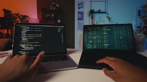 POV of a programmer reviewing code on laptop, testing software, remote work Stock Footage 303697601