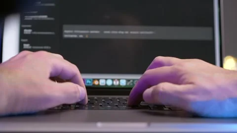 Pov programmer works on his laptop, a man quickly types text on his computer Stock Footage 254705528