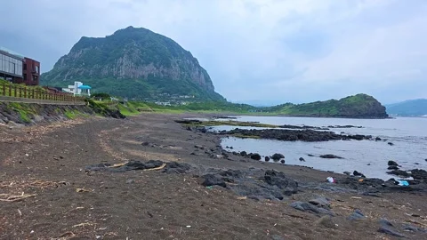 POV push in walking along Sagye Beach toward Sanbangsan mountain and Yongmeori Vídeo Stock 337978071
