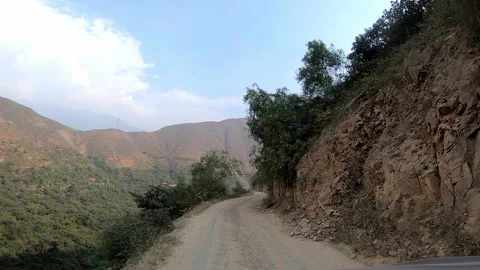 POV quick camera on the car driving on a narrow gauge road between rocks in the Stock Footage 198797787