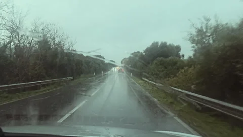 POV Rainy Drive With Windshield Wipers and Headlights Traffic Stock Footage 325812771