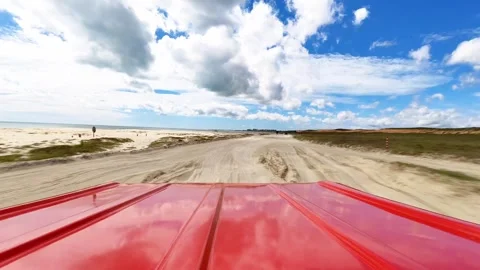 POV Rear View of Red Buggy Driving on Sand Dunes and Beach in Jericoacoara 動画素材 328615399