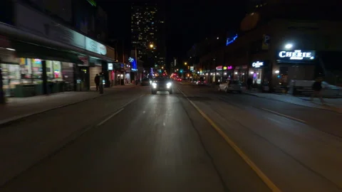 POV reverse night driving in downtown Toronto on dark city streets at night Stock Footage 145659608