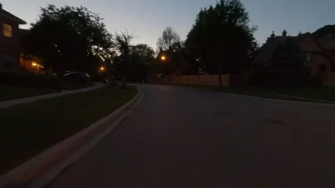 POV of reverse rear view shot driving on city streets at dusk Видео 156476773