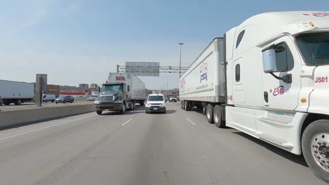 POV reverse shot driving on highway with truck and car traffic on nice day 動画素材 151887016