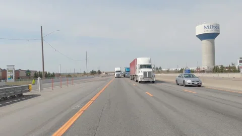 POV reverse shot driving on highway with truck and car traffic on nice day 库存影片 151896767