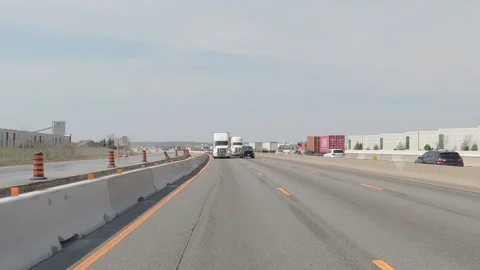 POV reverse shot driving on highway with truck and car traffic on nice day Vídeos de archivo 151897029