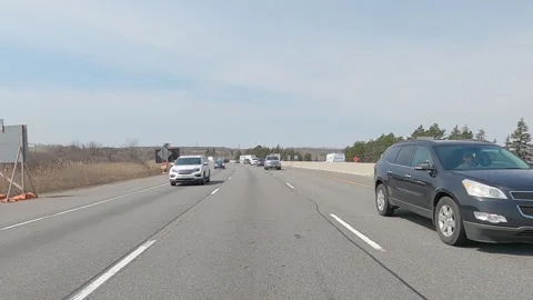 POV reverse shot driving on highway with truck and car traffic on nice day Vídeos de archivo 151897728