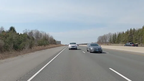 POV reverse shot driving on highway with truck and car traffic on nice day Vídeos de archivo 151898083