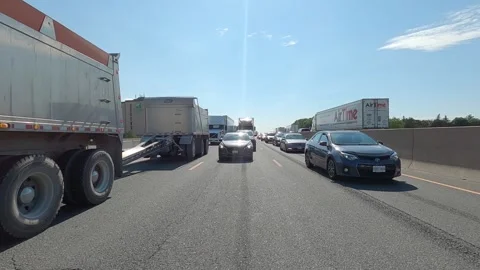 POV reverse shot driving plate tractor trailer trucks on highway del Видео 156448245