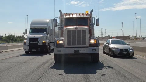 POV reverse shot driving plate tractor trailer trucks on highway del Видео 156450110