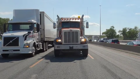 POV reverse shot driving plate tractor trailer trucks on highway del Stock Footage 156451173