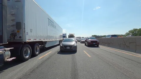 POV reverse shot driving plate on highway with truck and car traffic Video stock 156479375